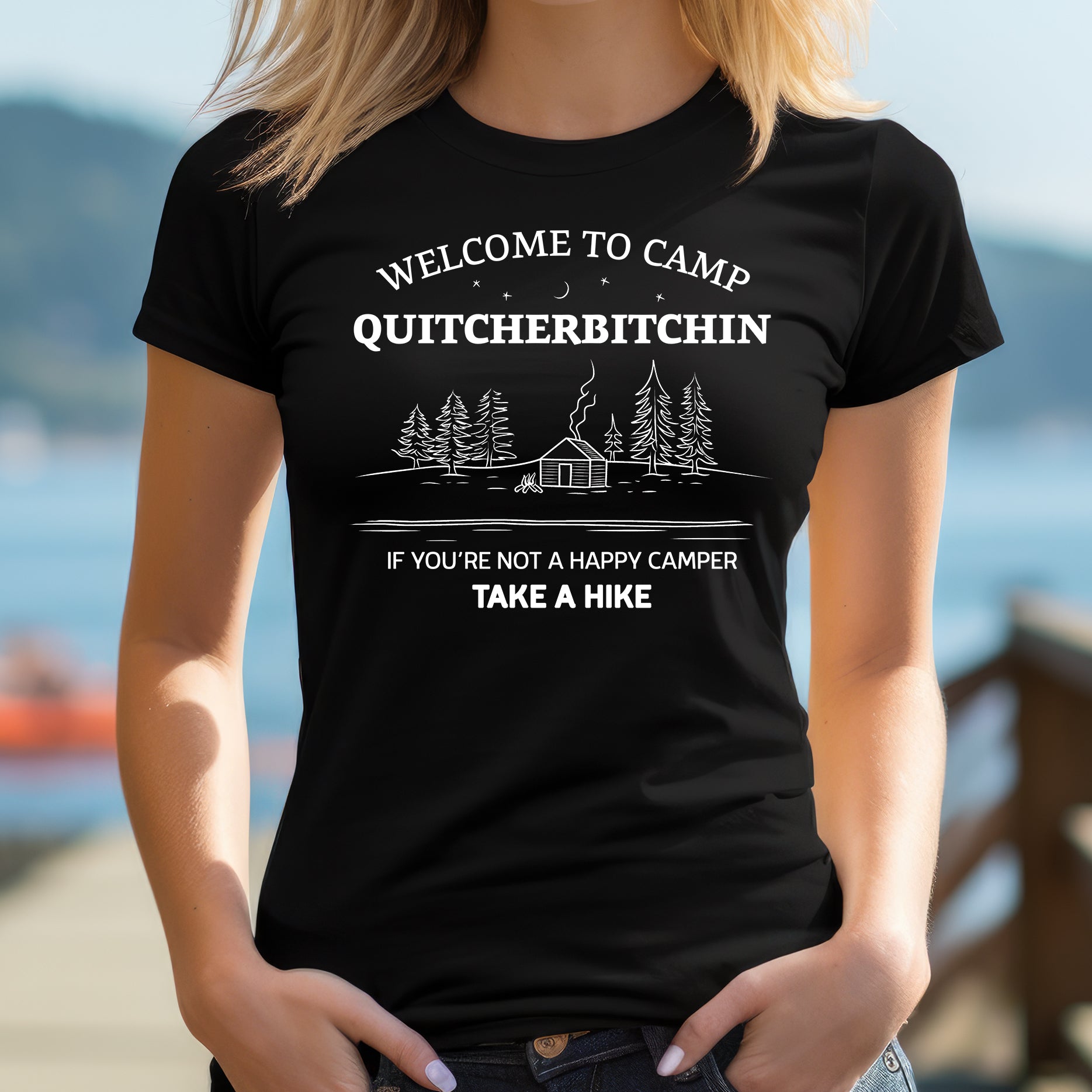 Woman in outdoor setting wearing black Camp Quitcherbitchin T-shirt with funny camp cabin design
