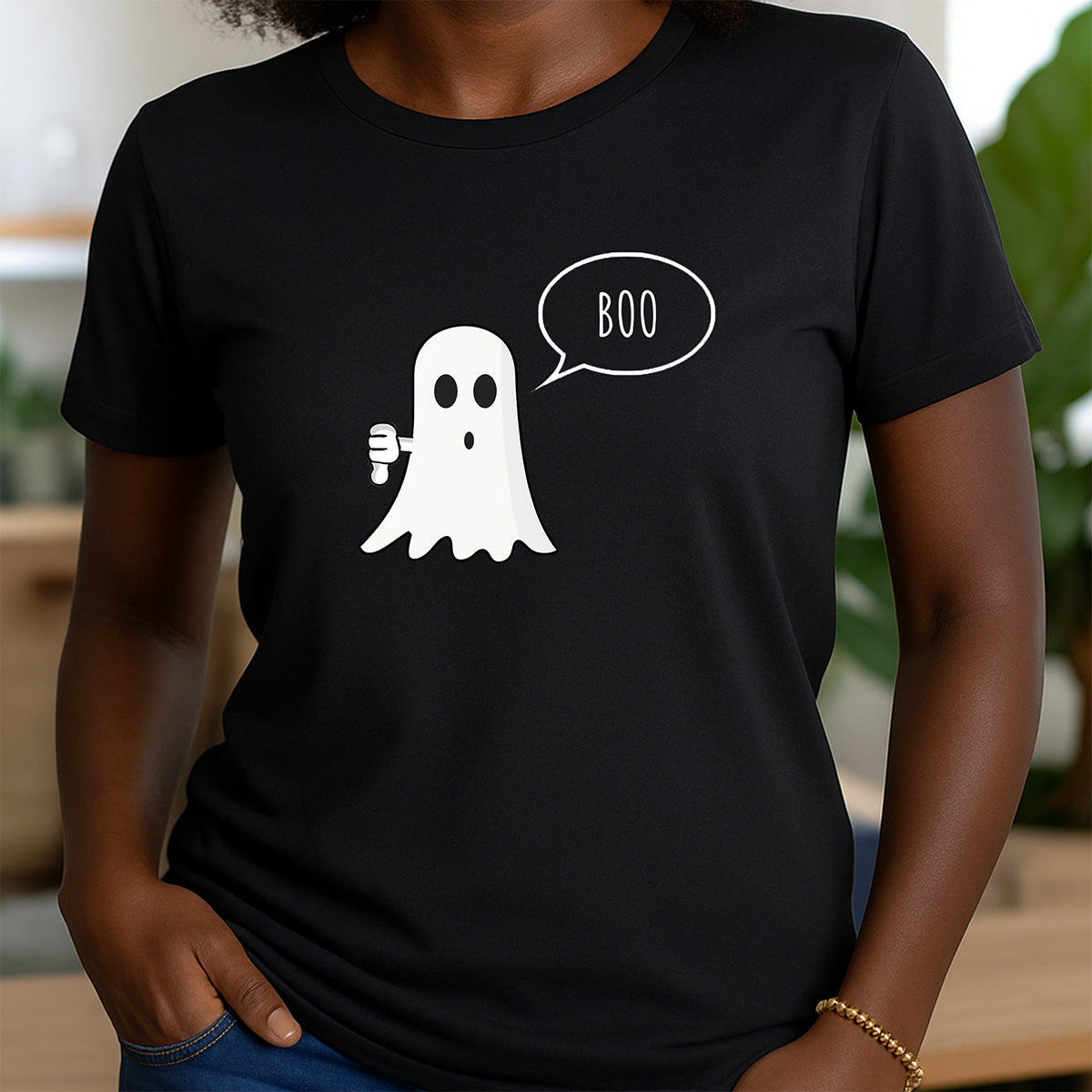 Woman wearing black crewneck shirt with ghost graphic saying Boo and giving thumbs down