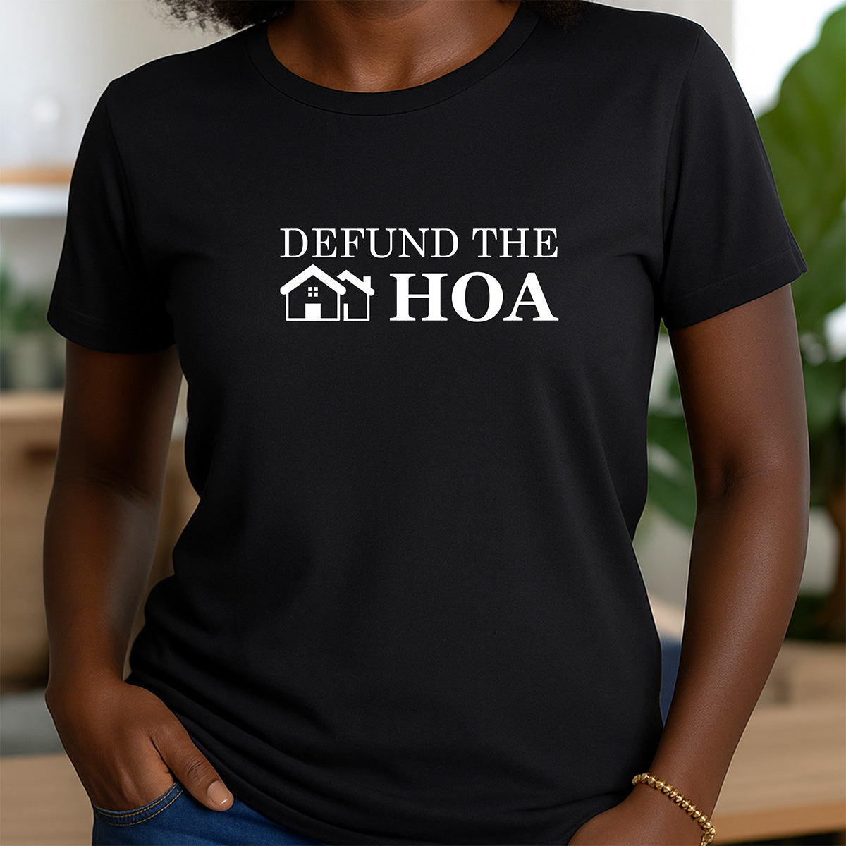 Woman wearing black crewneck t-shirt with Defund the HOA text and simple house icon