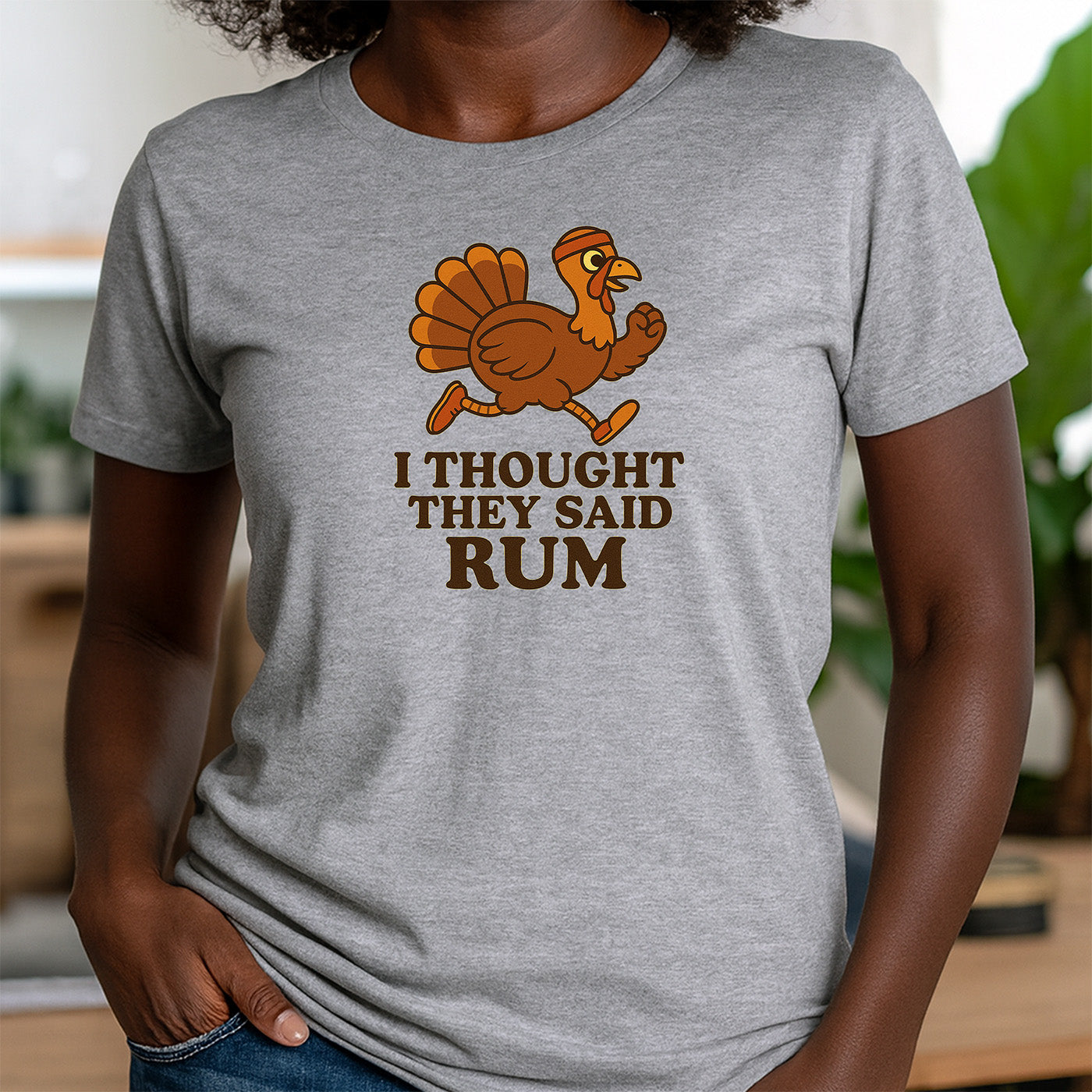 woman in gray crew neck t-shirt with cute running turkey and phrase i thought they said rum