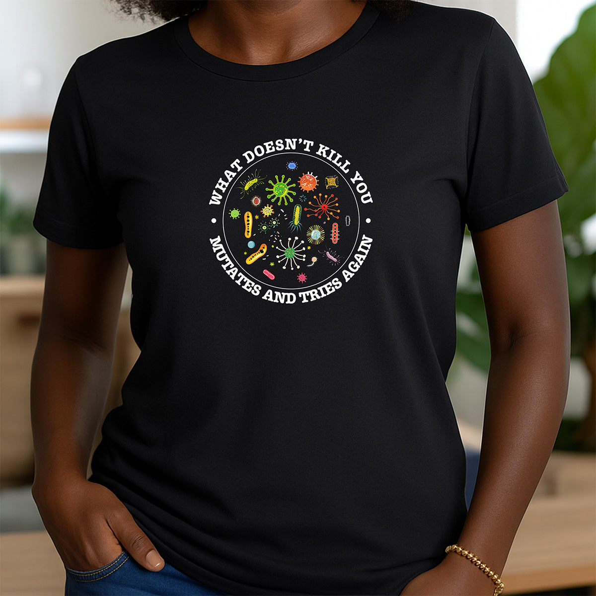 Woman wearing black crewneck t-shirt with germs graphic and text What Doesn’t Kill You Mutates and Tries Again funny tee