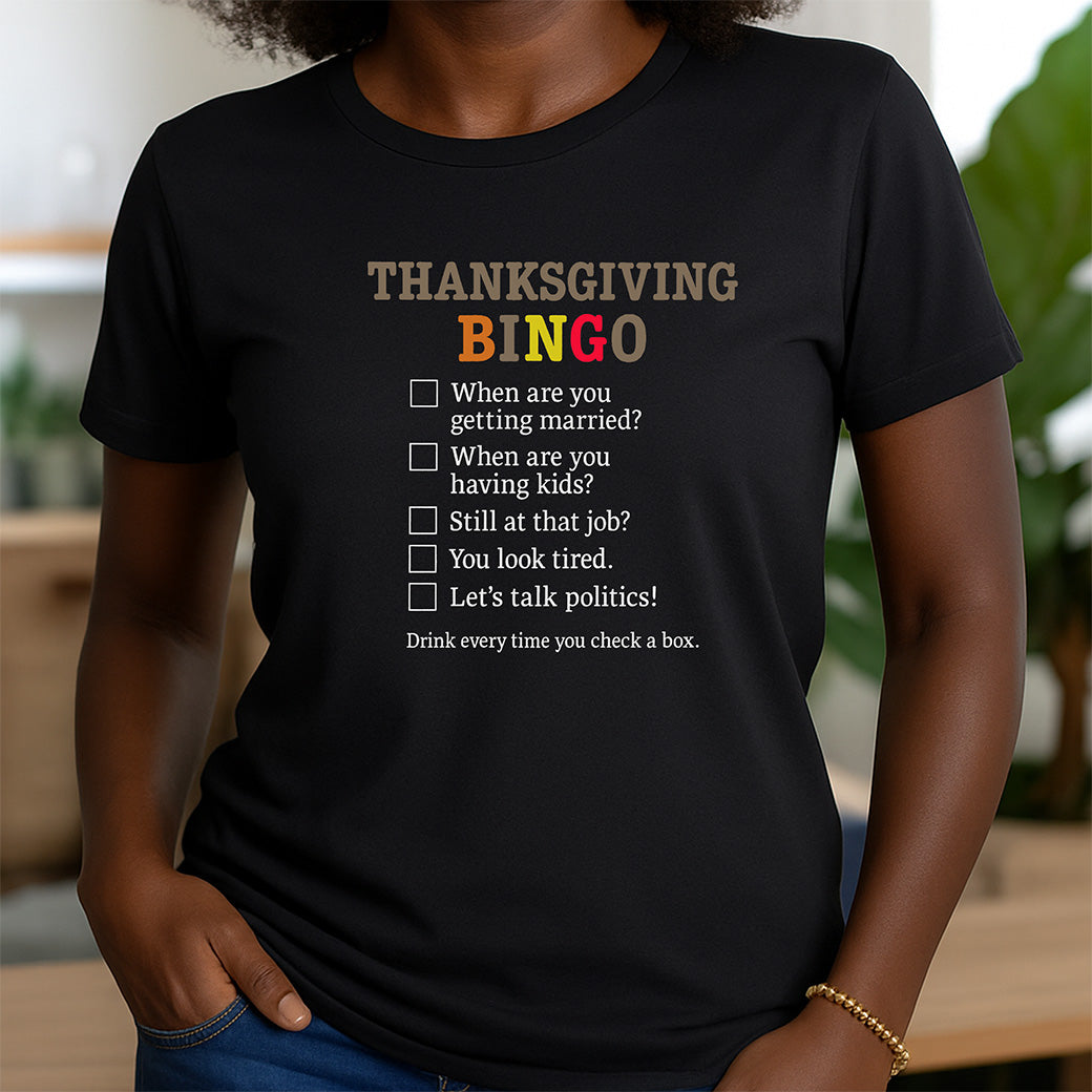 woman in black crew neck t-shirt featuring thanksgiving bingo design with colorful text and checklist