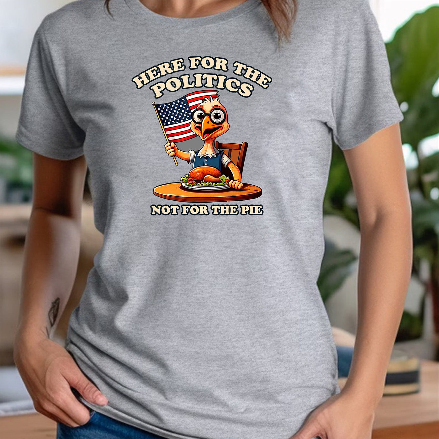 woman in crew neck gray t-shirt with turkey illustration and funny phrase here for the politics not for the pie