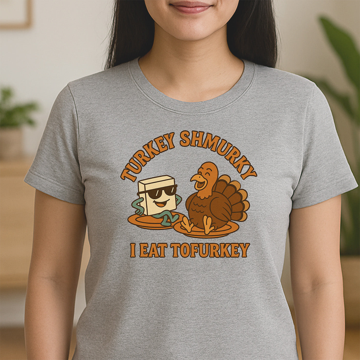 woman wearing gray crew neck t-shirt featuring tofu and turkey graphic with text turkey shmurky i eat tofurkey