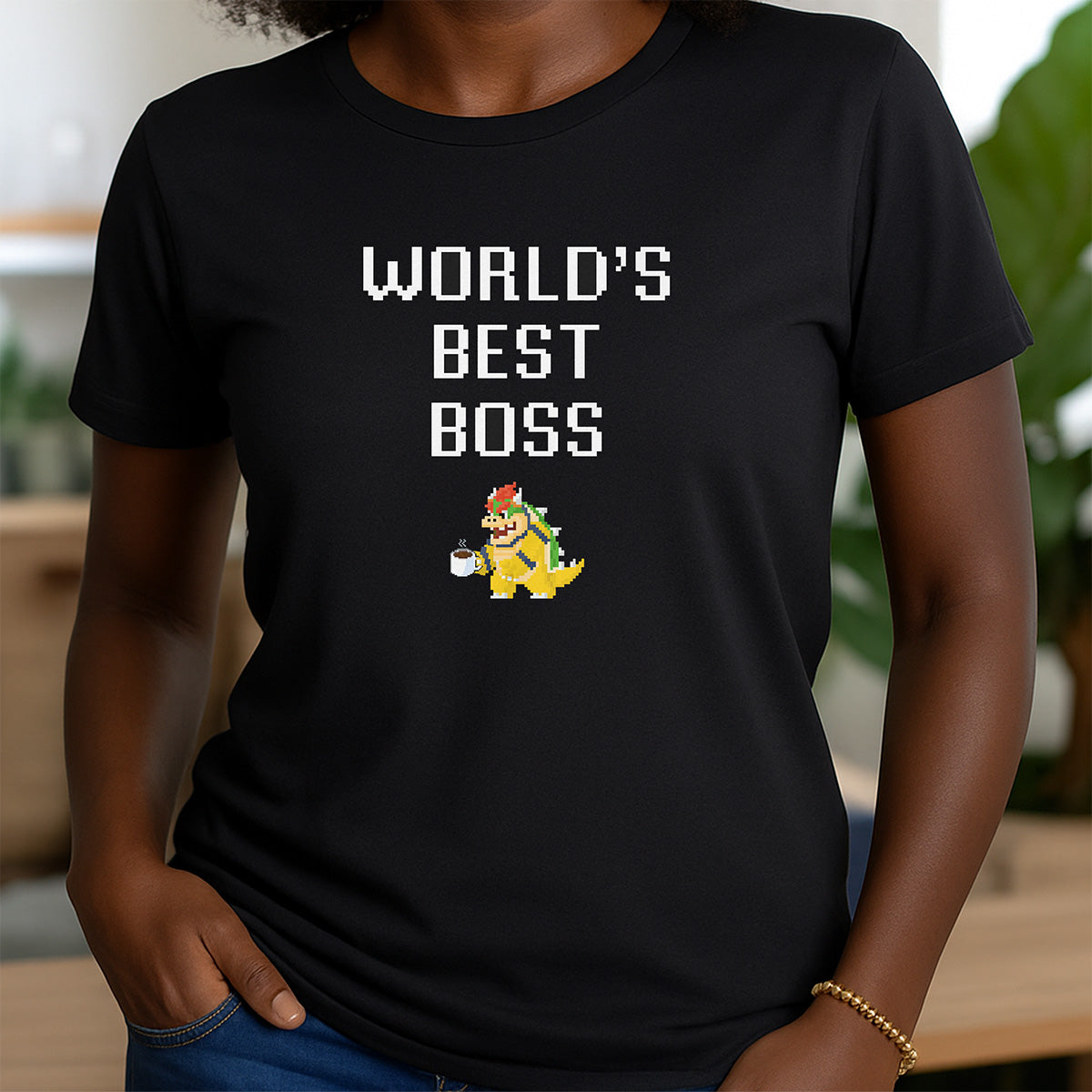 Woman wearing black crewneck shirt with pixel Bowser and World’s Best Boss caption