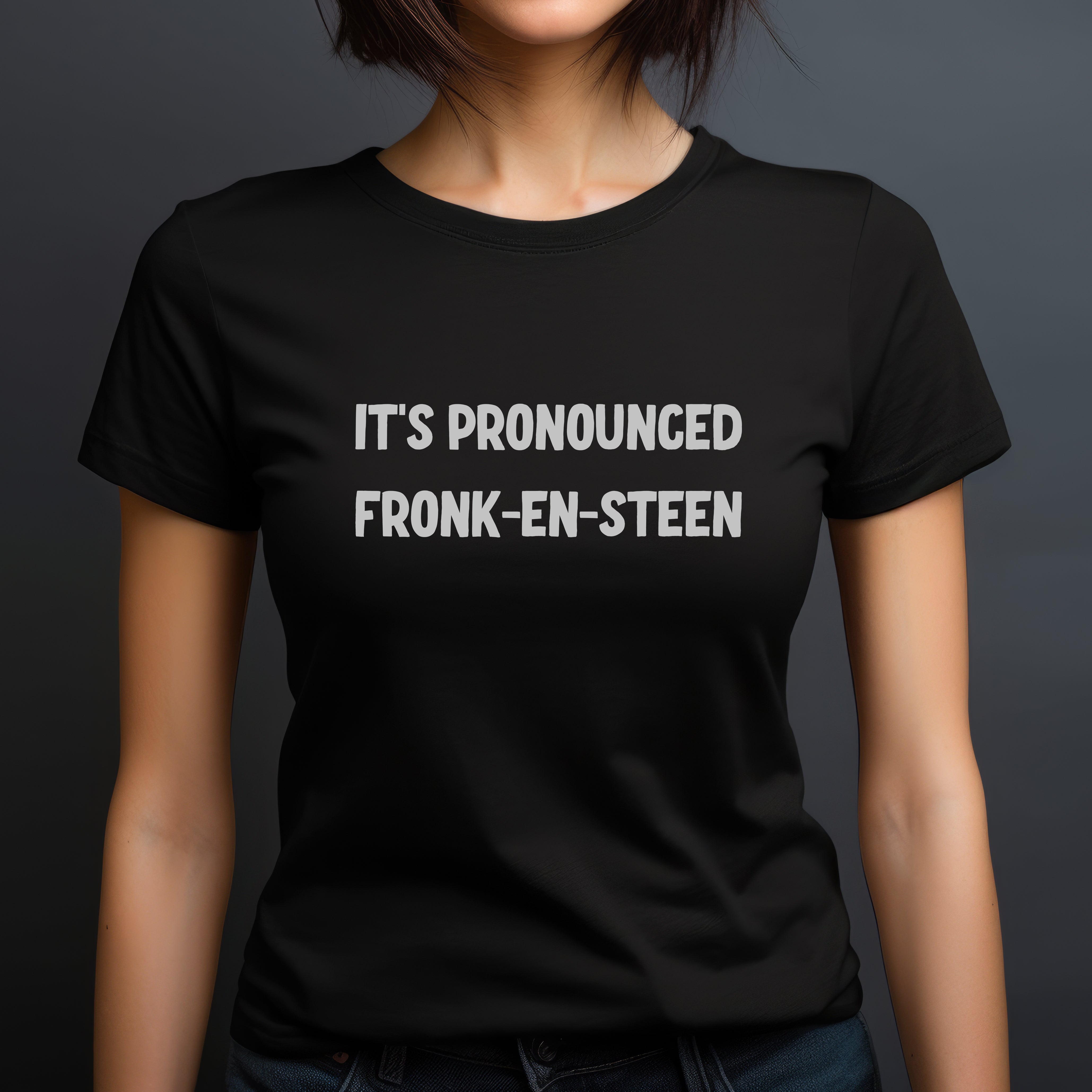 Woman wearing a fitted black Halloween t-shirt with white phrase It’s Pronounced Fronk-en-Steen