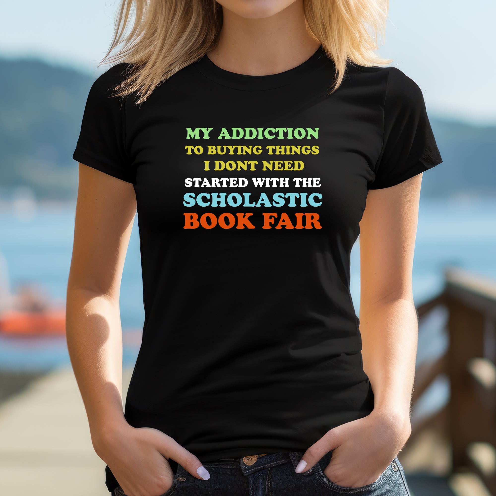 Woman outdoors wearing fitted black Scholastic Book Fair addiction graphic T-shirt.