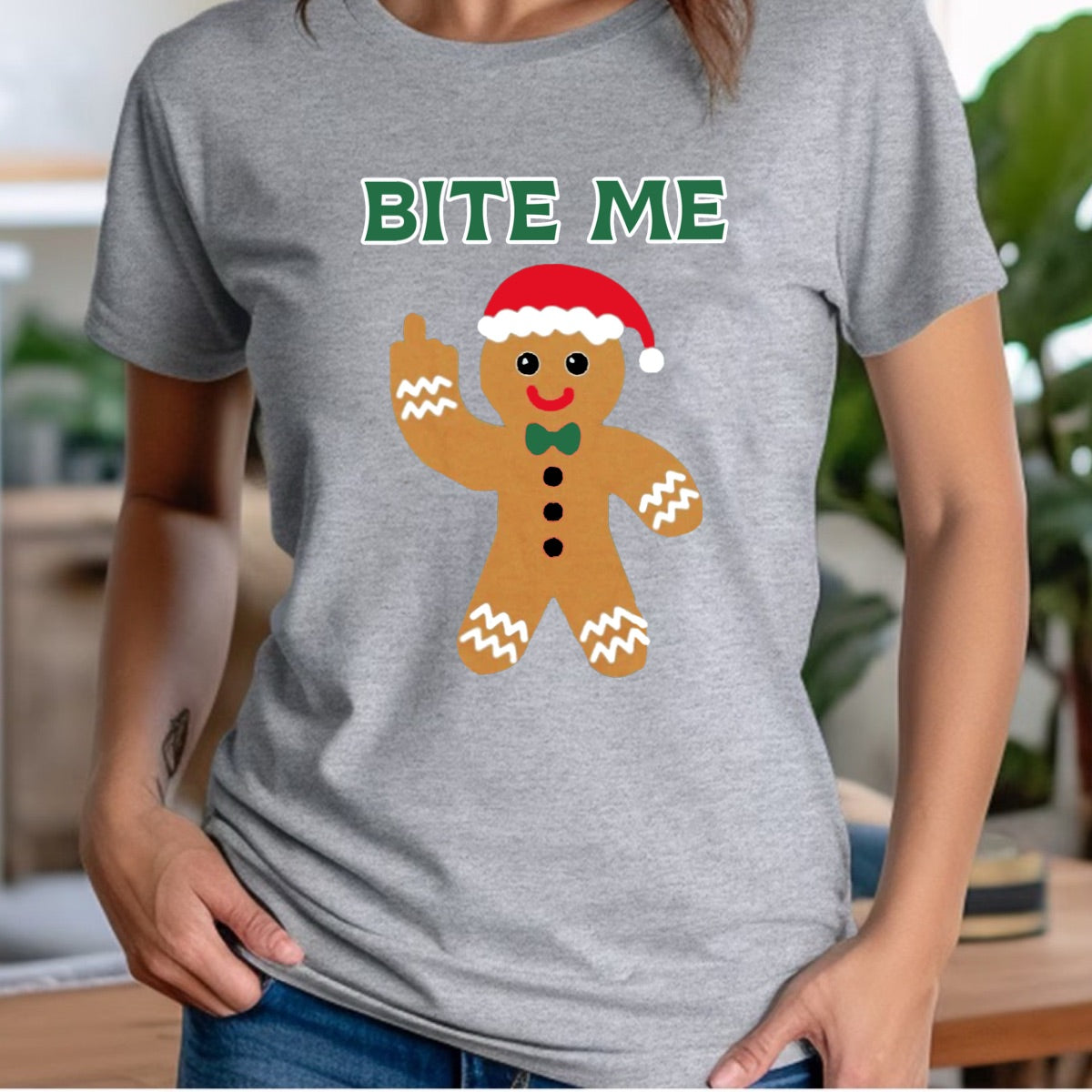 Woman in grey Christmas crew tee with gingerbread Bite Me holiday design