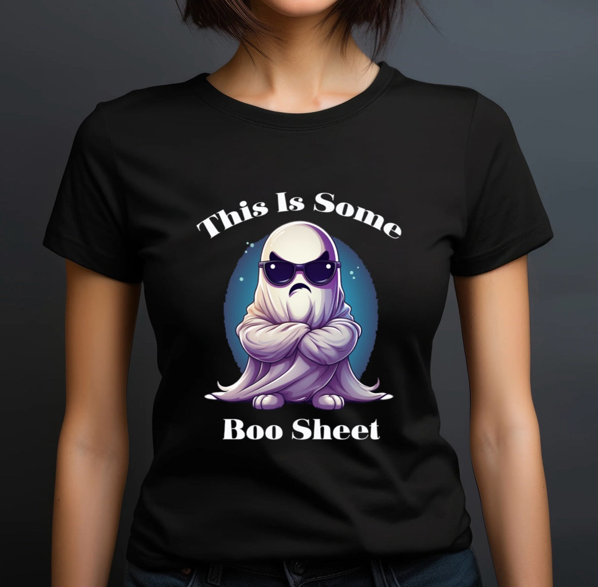 woman modeling black halloween shirt with cartoon ghost design and the phrase this is some boo sheet