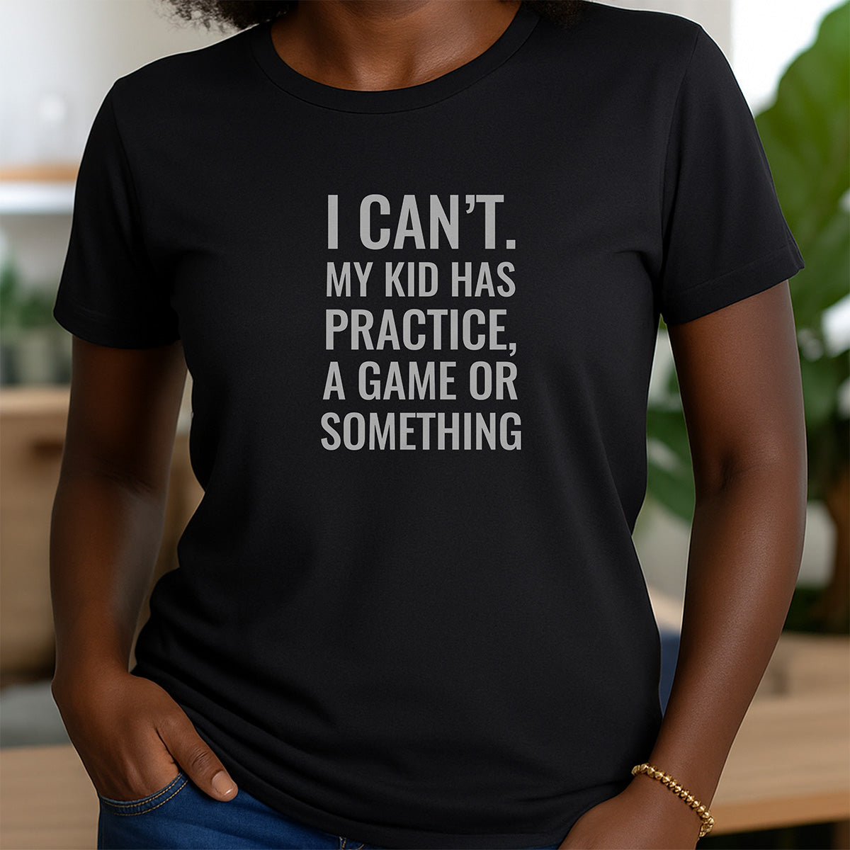 Woman in black crewneck t-shirt with I Can’t My Kid Has Practice Game Or Something humorous parent quote design