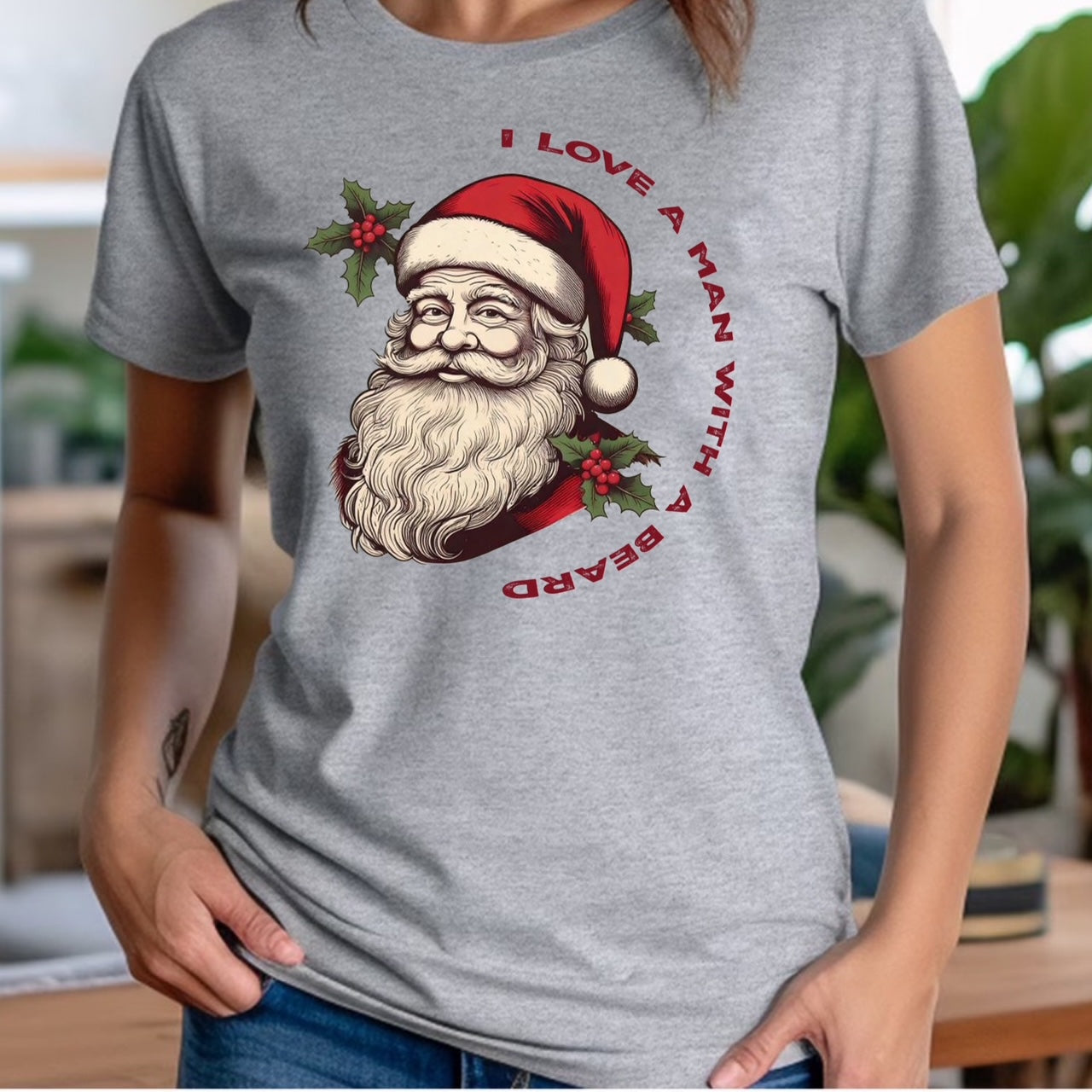 Woman in grey crew neck Christmas shirt featuring Santa Claus face and text I love a man with a beard
