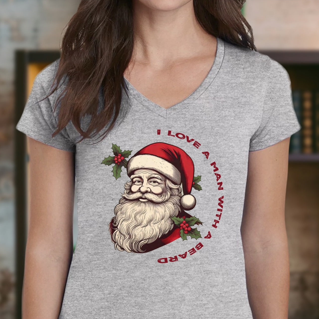 Woman wearing grey v-neck Christmas t-shirt with Santa Claus design and I love a man with a beard text