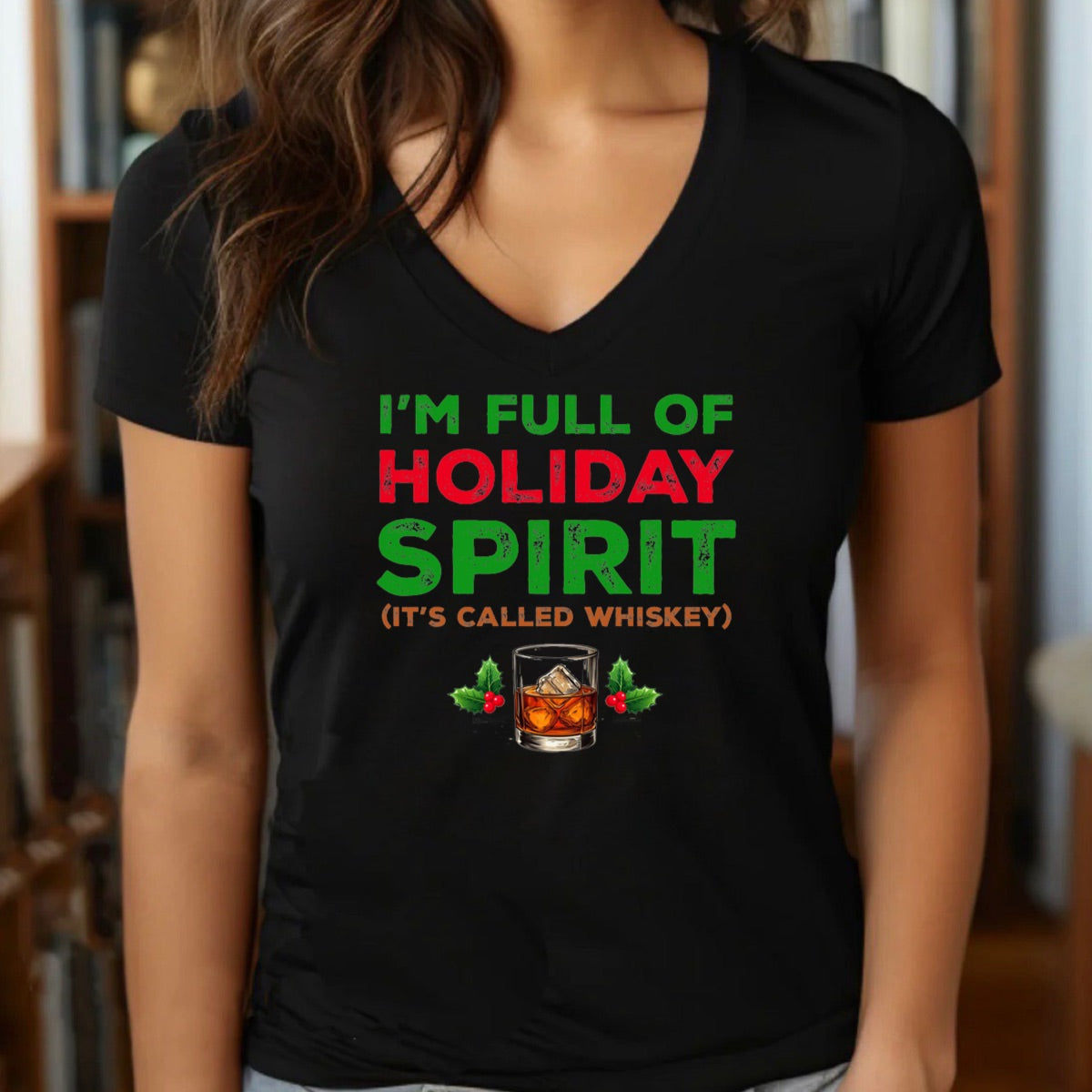 Woman in v-neck holiday whiskey spirit Christmas t-shirt with green and red festive text and whiskey glass design