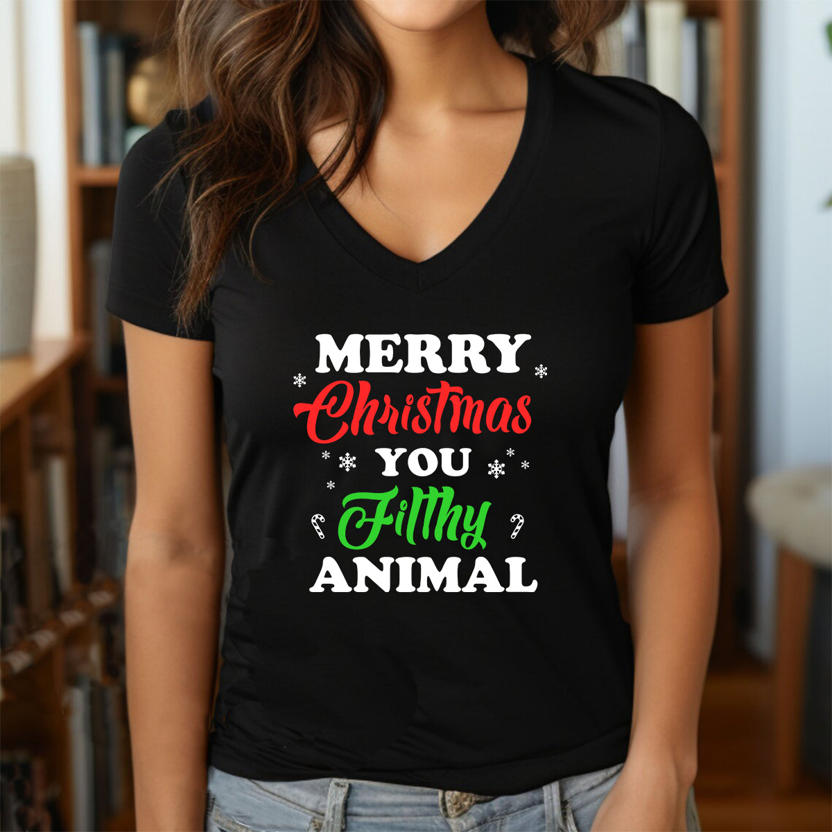Woman wearing v-neck black t-shirt with Merry Christmas You Filthy Animal holiday design