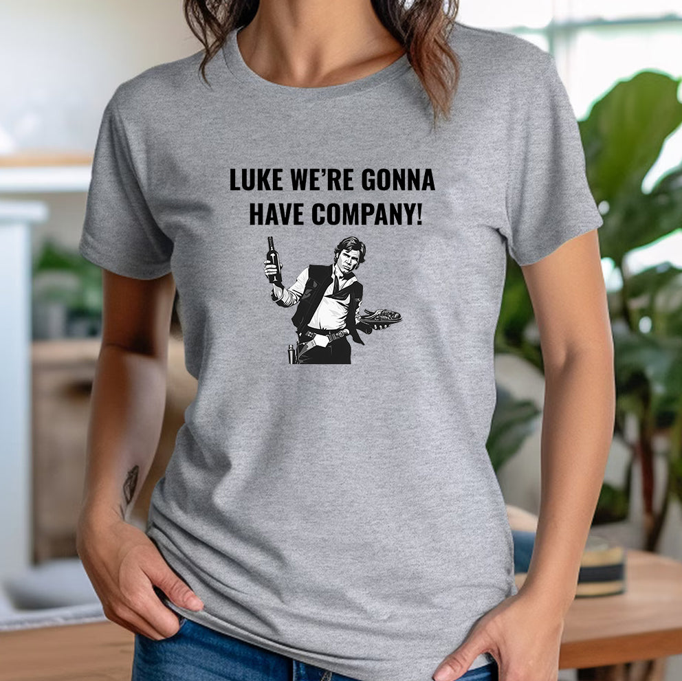 Woman modeling a grey Star Wars Han Solo graphic T-shirt with bold text “Luke we’re gonna have company!”.