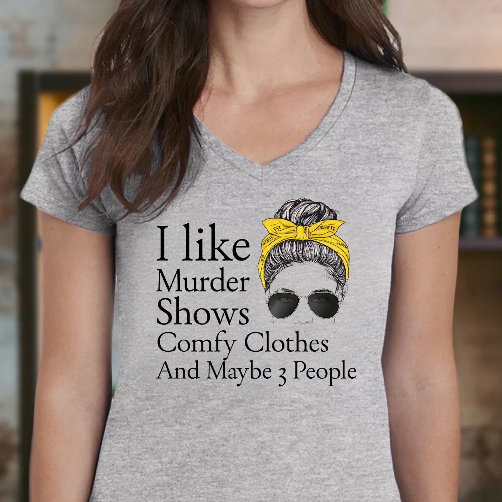 Women’s heather gray v-neck tee with Murder Shows Comfy Clothes And Maybe 3 People quote and bun graphic