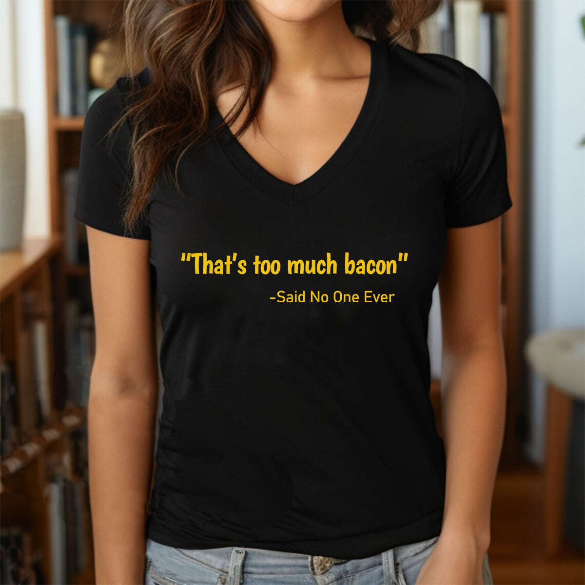 Woman in black v-neck t-shirt with yellow quote That’s too much bacon said no one ever styled with jeans
