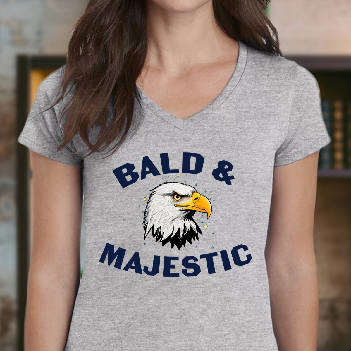 Woman wearing grey v-neck t-shirt with Bald & Majestic bald eagle illustration