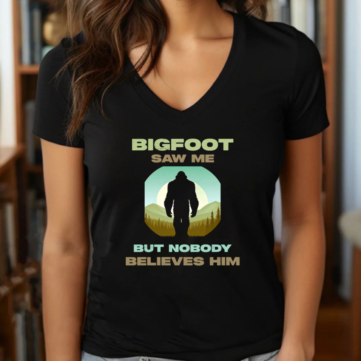 Woman wearing v-neck Bigfoot saw me but nobody believes him shirt in black with vintage outdoors graphic print