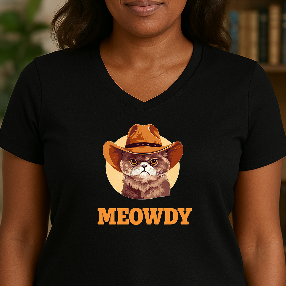Woman in black V-neck MEOWDY cowboy cat shirt with cowboy hat cat graphic, playful Western style