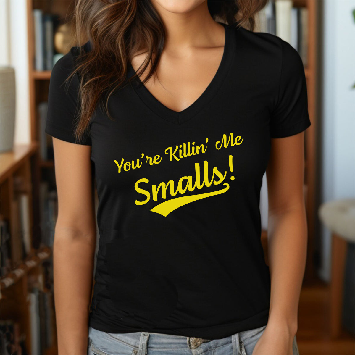 Woman in black v-neck t-shirt with yellow You're Killin' Me Smalls funny quote text design