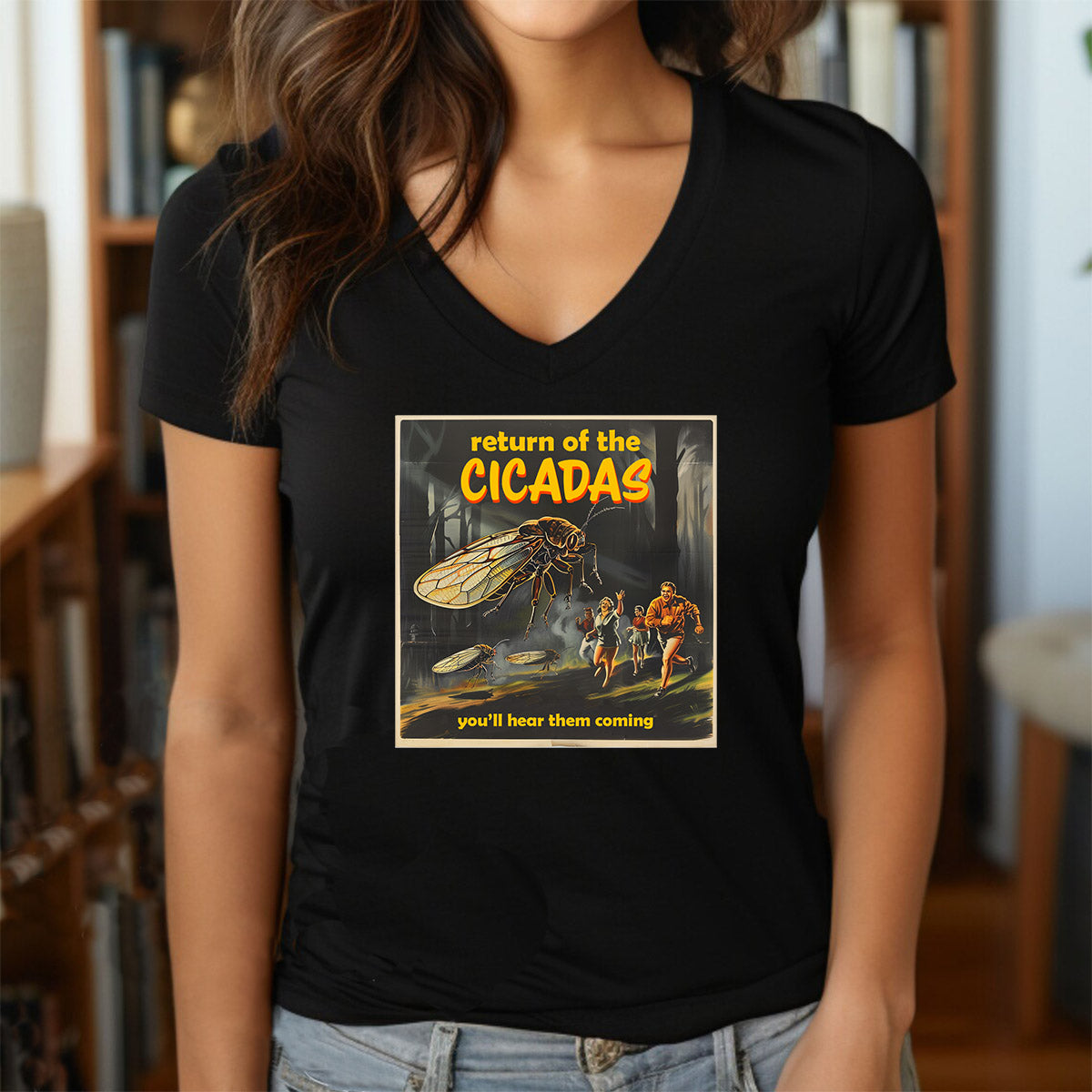 Woman in black V-neck shirt with retro cicada attack graphic and text “Return of the Cicadas.”