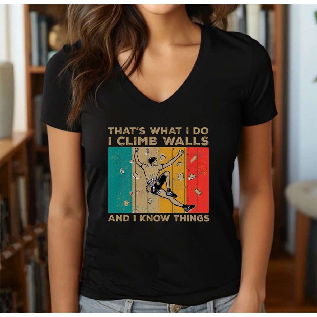 Woman wearing v-neck climbing shirt with retro colored stripes and climber design reading That's What I Do I Climb Walls And I Know Things