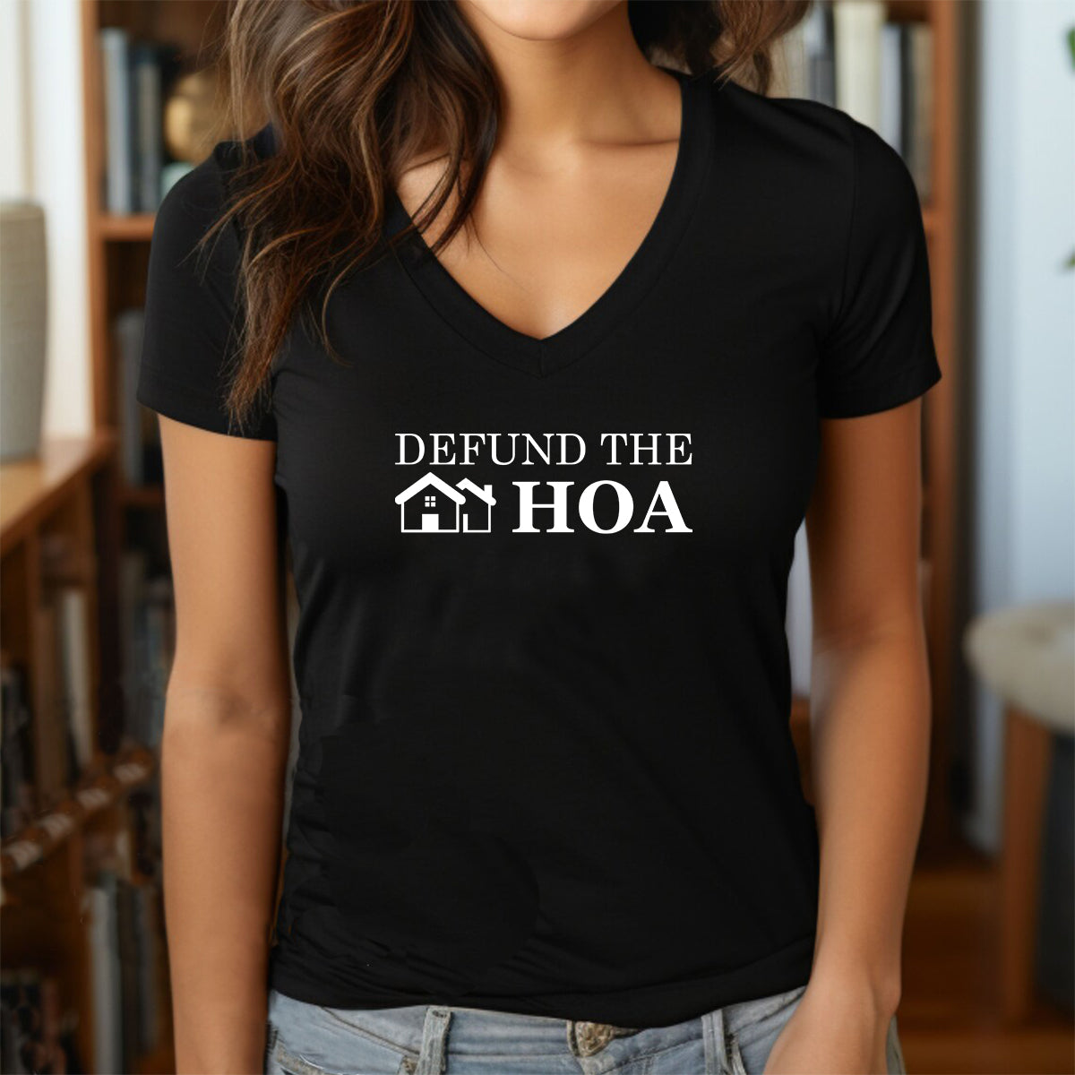 Woman in black v-neck t-shirt with white Defund the HOA slogan and house design