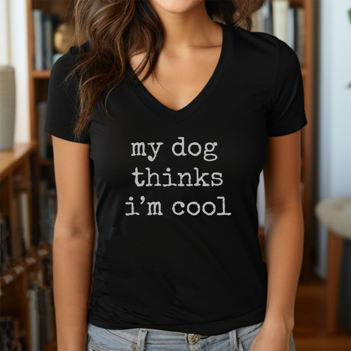 Woman in black v-neck t-shirt featuring playful text “my dog thinks I’m cool