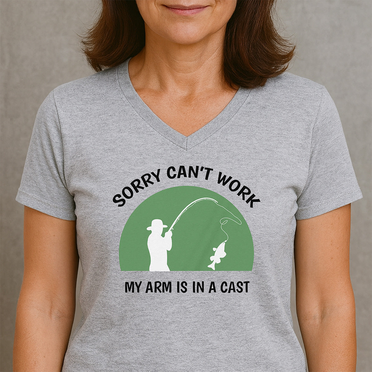 Woman in heather gray V-neck T-shirt featuring fisherman silhouette and hooked fish, text Sorry can’t work, my arm is in a cast.