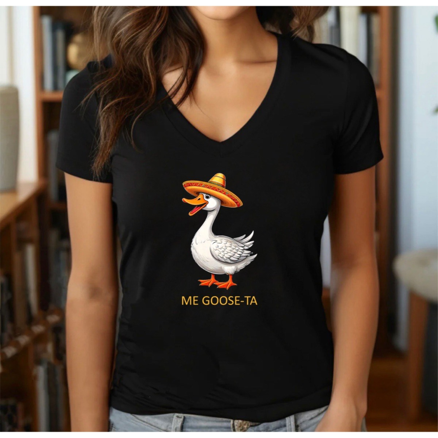 Woman in black v-neck t-shirt with cartoon goose in sombrero and Me Goose-Ta pun design