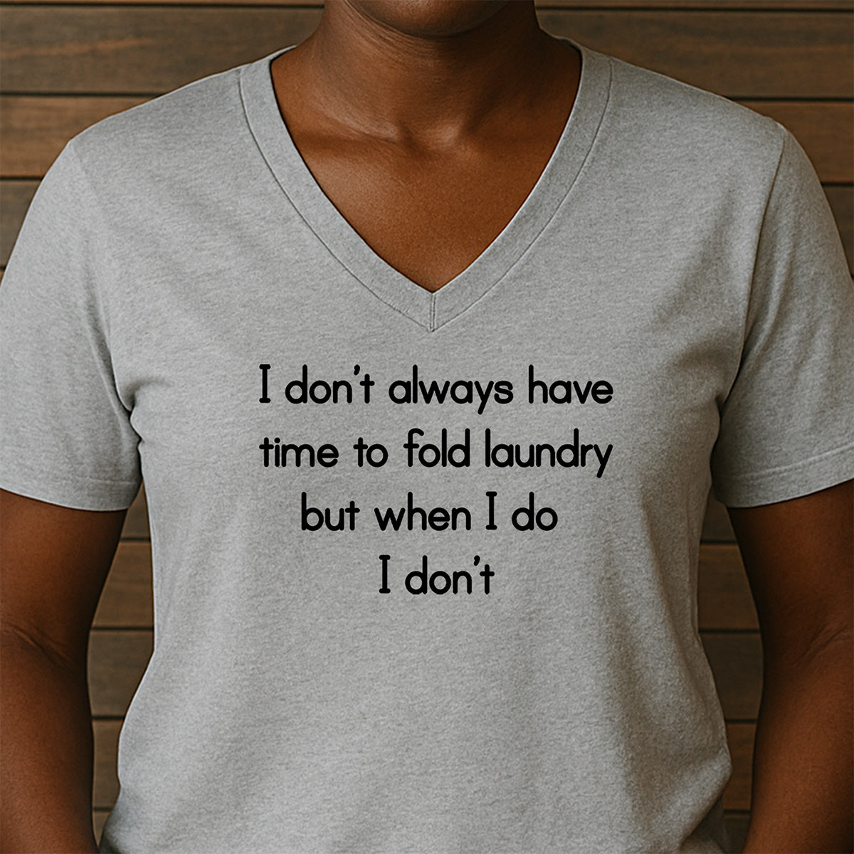 Woman in v-neck heather gray shirt with funny quote: I don’t always have time to fold laundry, but when I do I don’t.