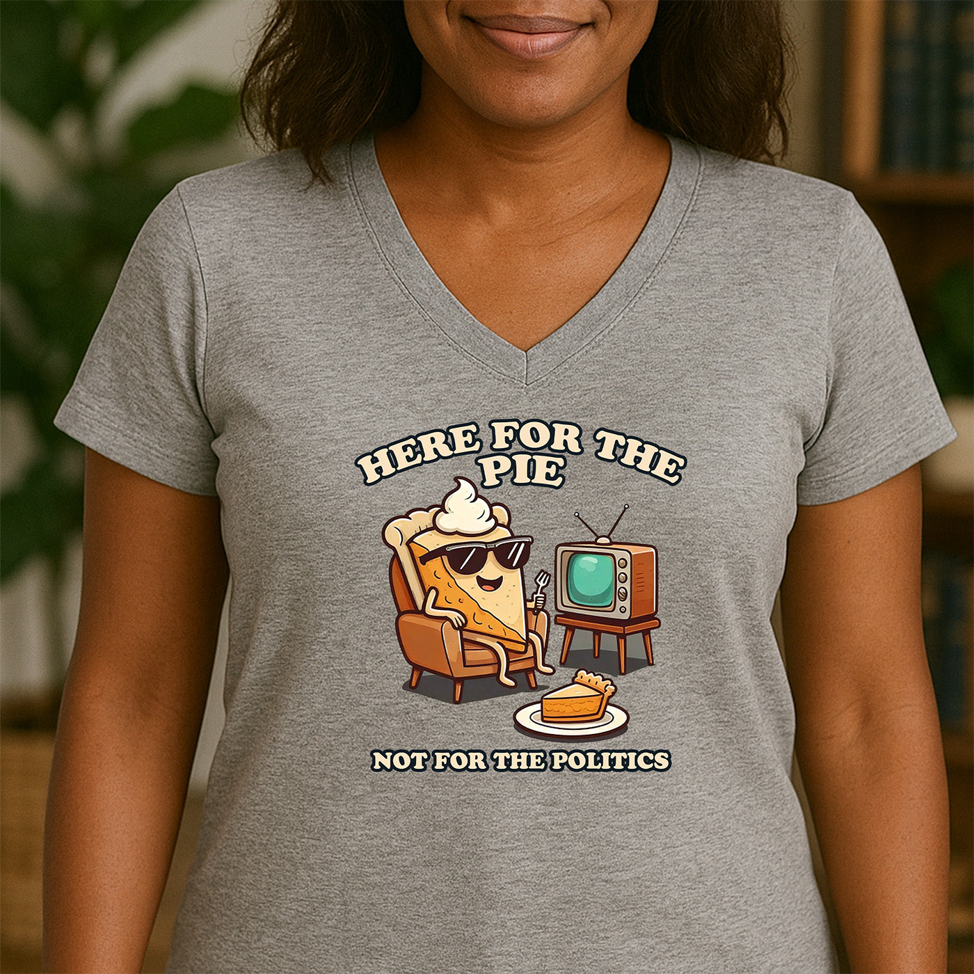 woman wearing v-neck gray t-shirt with cute pie character design and saying here for the pie not for the politics