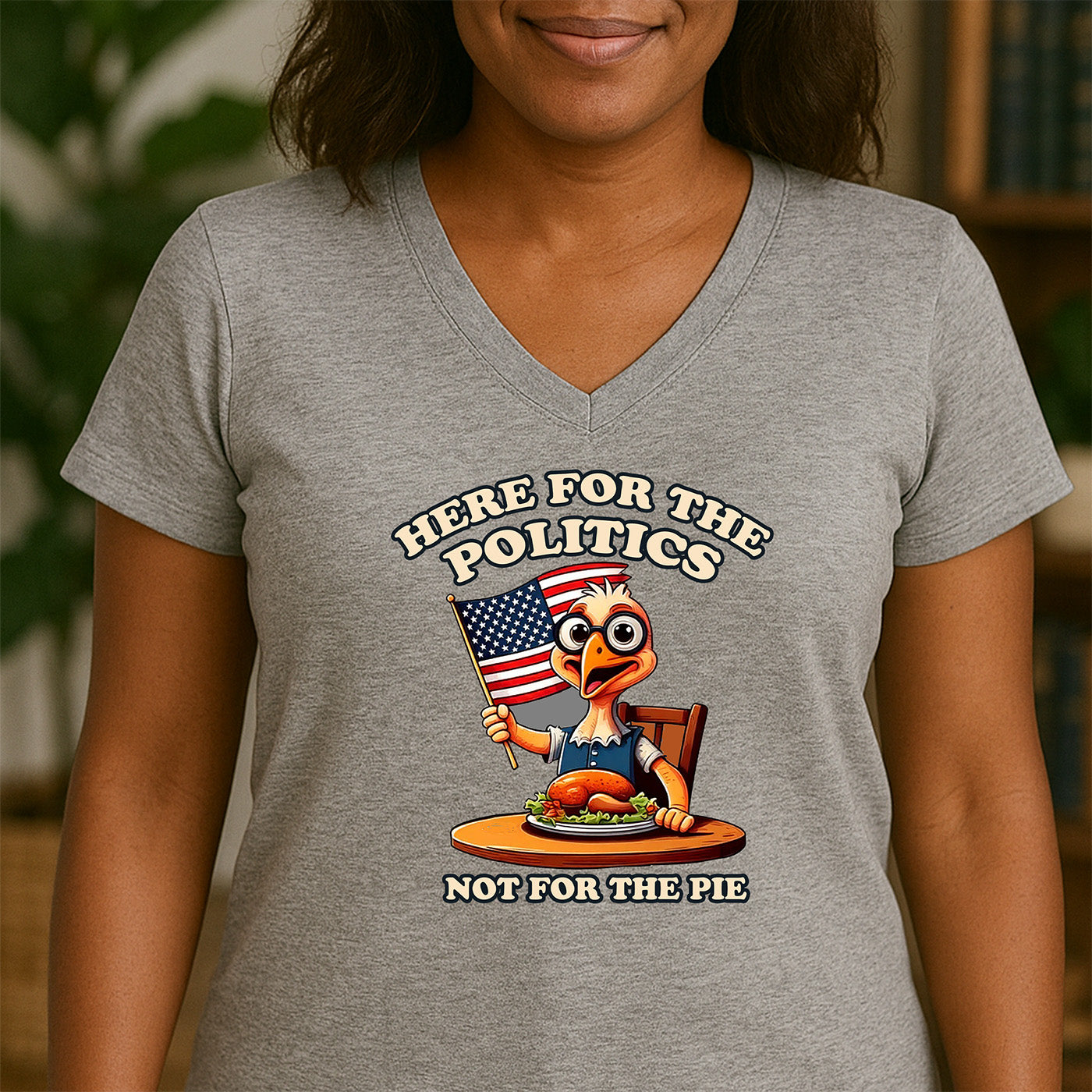 woman wearing v-neck gray t-shirt with patriotic turkey graphic and words here for the politics not for the pie