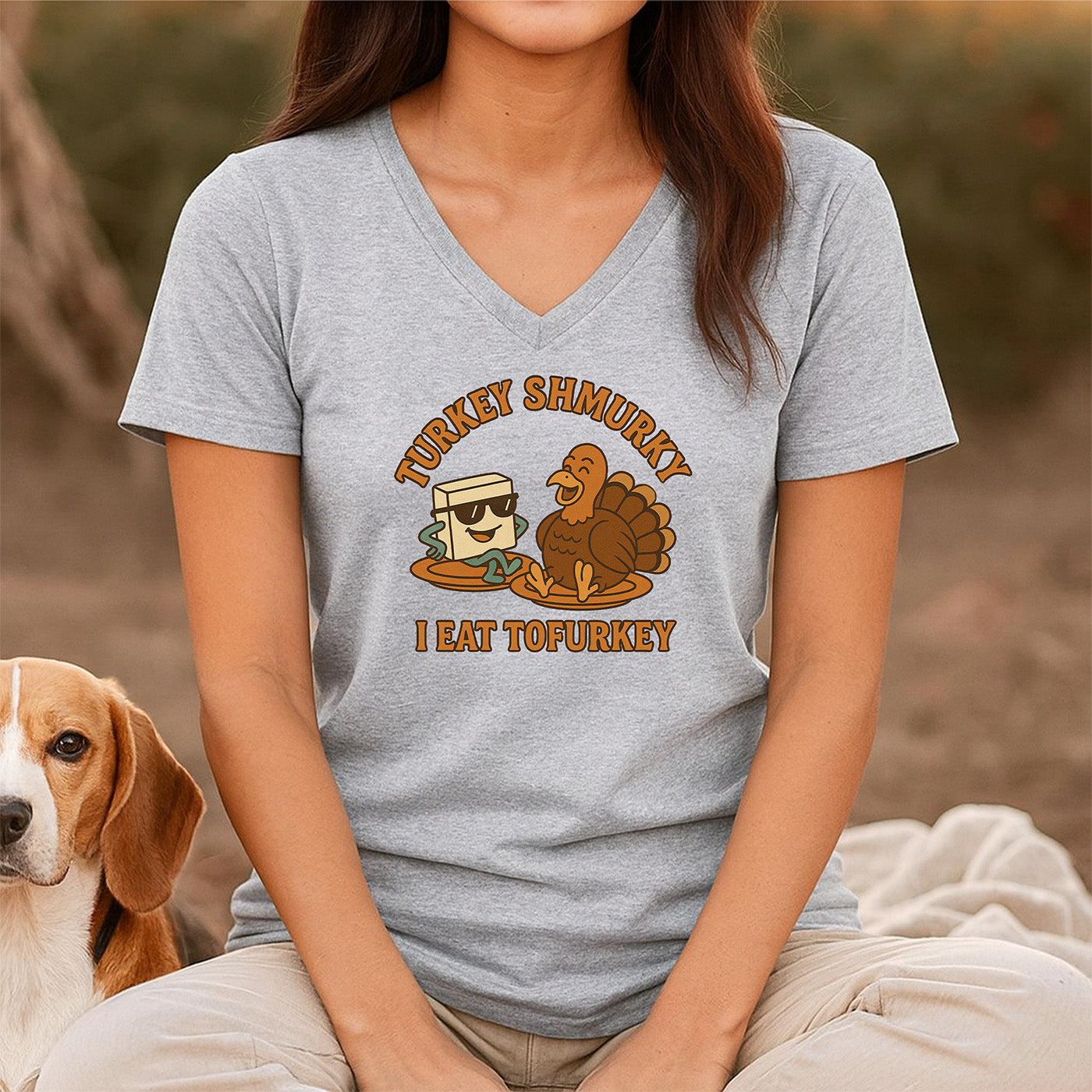 woman in gray v-neck t-shirt with tofu and turkey cartoon and words turkey shmurky i eat tofurkey funny vegan tee