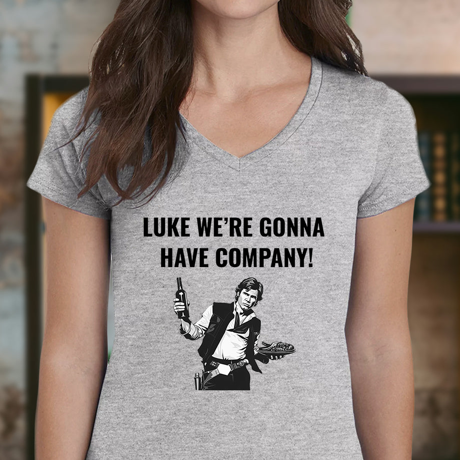 Woman wearing V-neck grey T-shirt featuring Han Solo design and the quote “Luke we’re gonna have company!”.