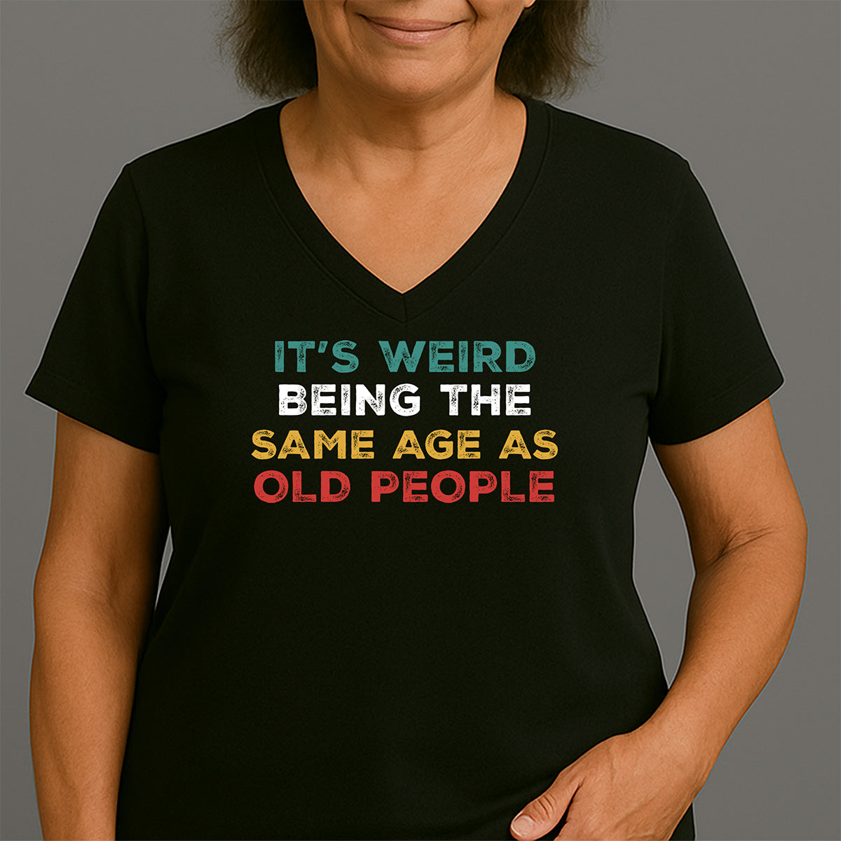 Women’s black V-neck tee displaying It’s Weird Being The Same Age As Old People in teal, white, gold, red; sarcastic birthday present