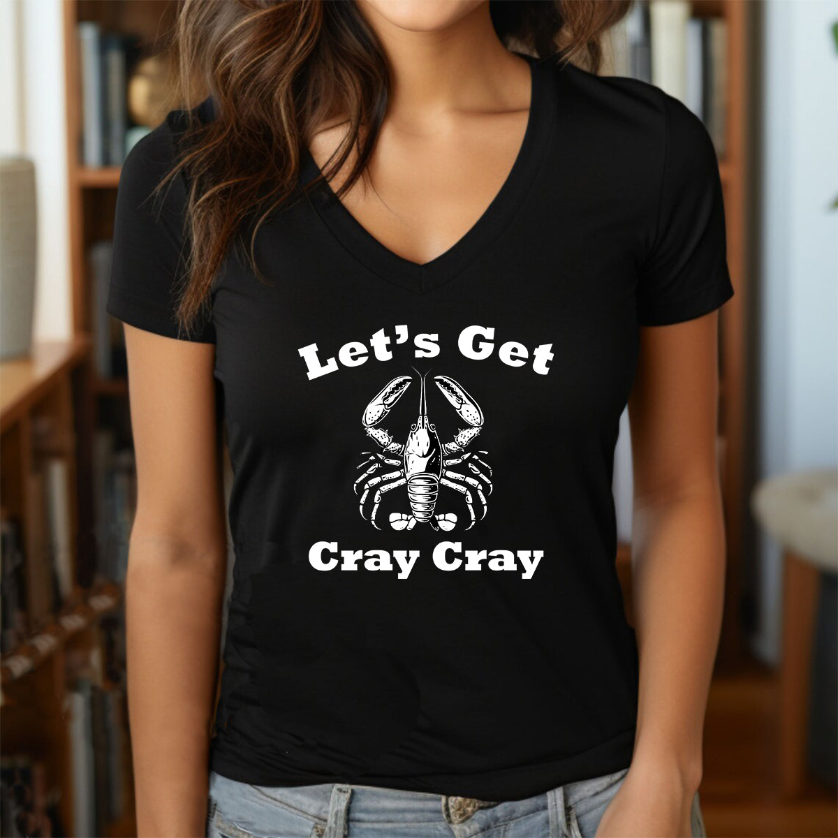 Woman in v-neck black t-shirt with lobster design and text lets get cray cray