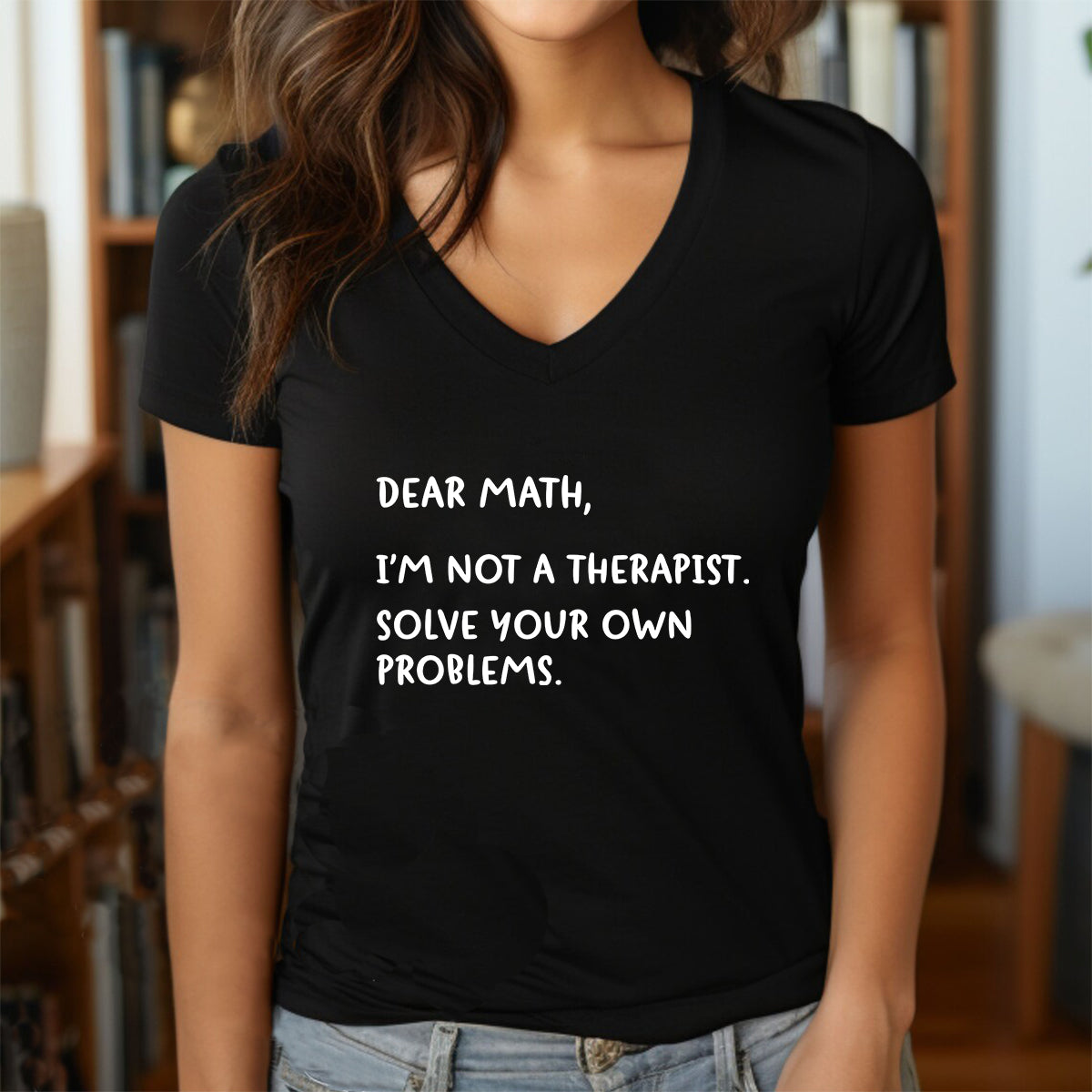 Woman wearing black v-neck funny math shirt with white text saying Dear Math solve your own problems