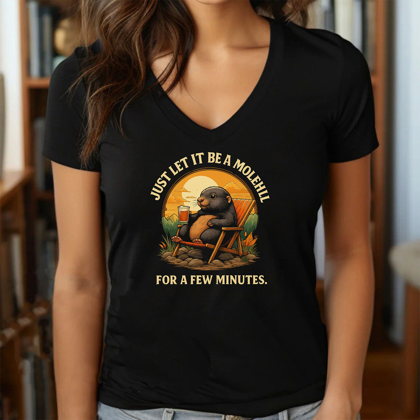 woman wearing v-neck black t-shirt with relaxed mole artwork and phrase just let it be a molehill for a few minutes