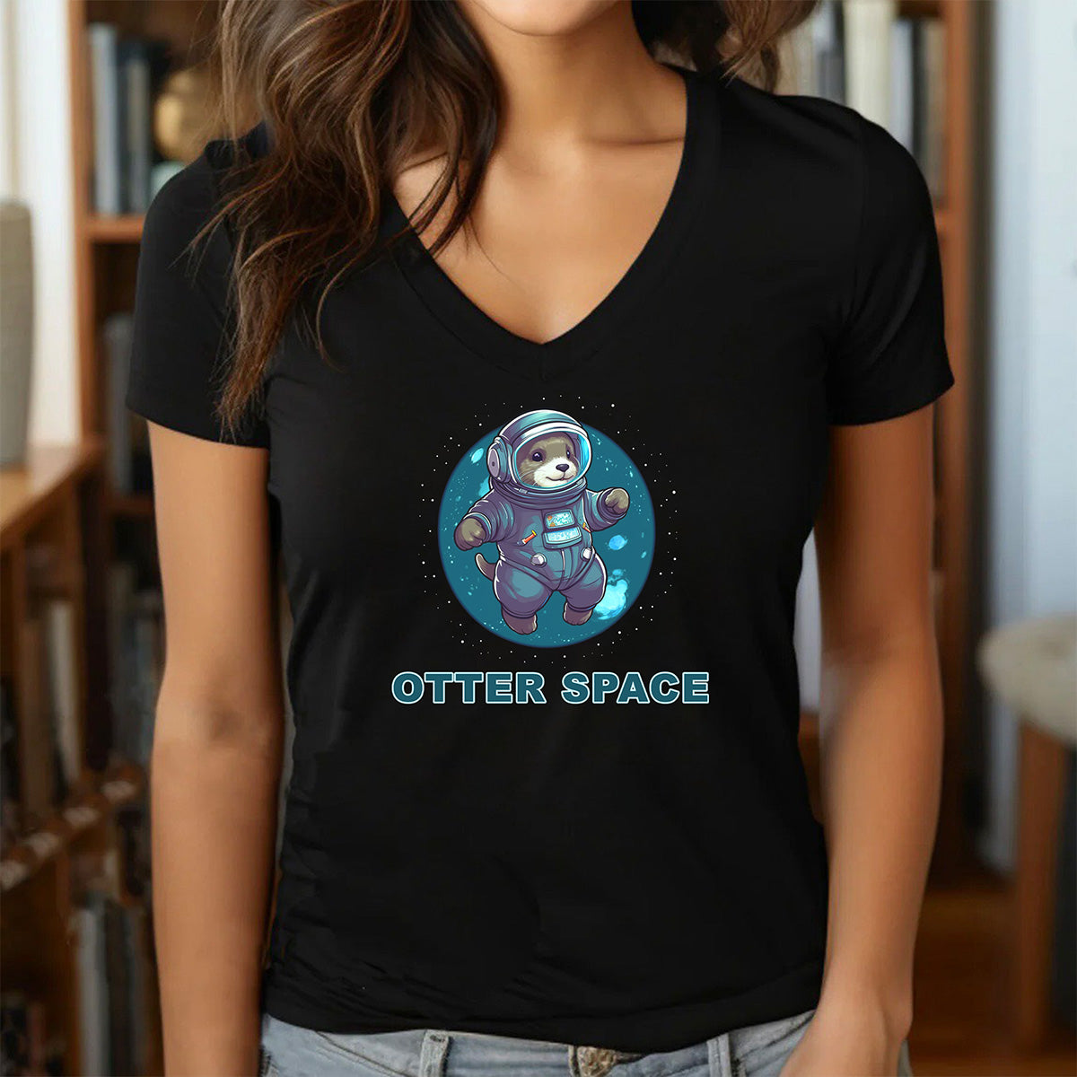 Woman in black V-neck shirt with otter astronaut graphic and OTTER SPACE wording, flattering casual style.