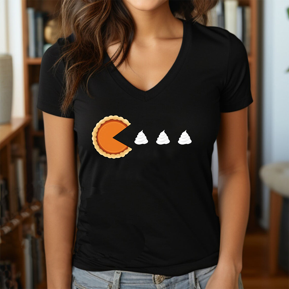 Woman in black V-neck with pumpkin pie Pac-Man graphic and whipped cream dots