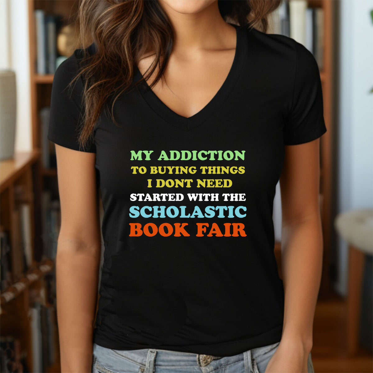 Woman in a black V-neck T-shirt with colorful Scholastic Book Fair design.
