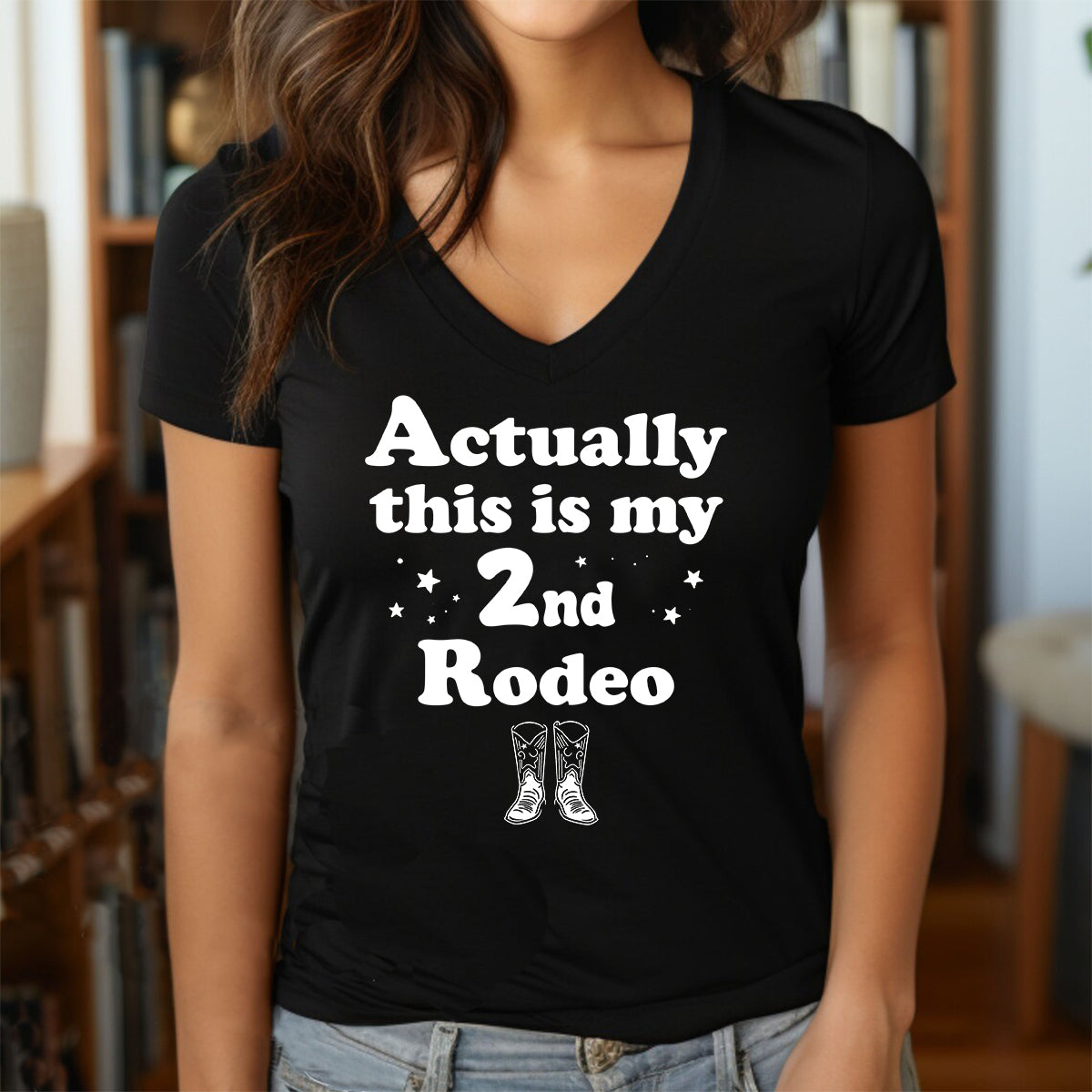 Woman in v-neck t-shirt with white text Actually this is my 2nd Rodeo and cowboy boots graphic