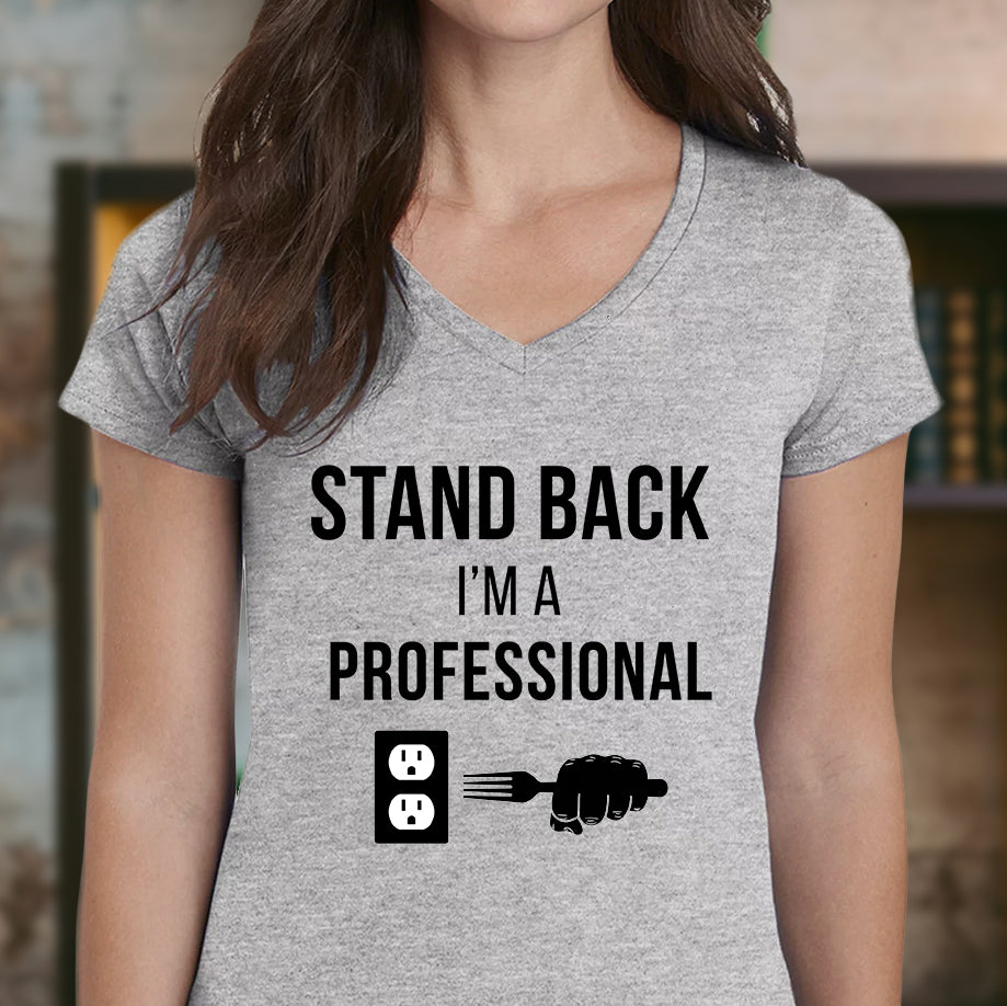 Woman wearing grey v-neck Stand Back I'm a Professional t-shirt with comical outlet and fork graphic