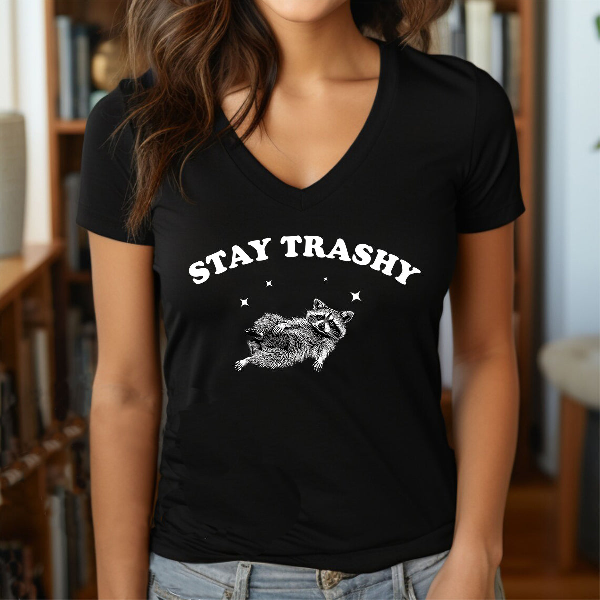 Woman in black V-neck “Stay Trashy” raccoon T-shirt casual outfit.