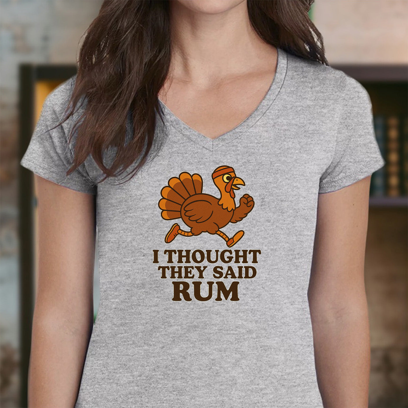 woman wearing gray v-neck t-shirt with funny thanksgiving running turkey and text i thought they said rum