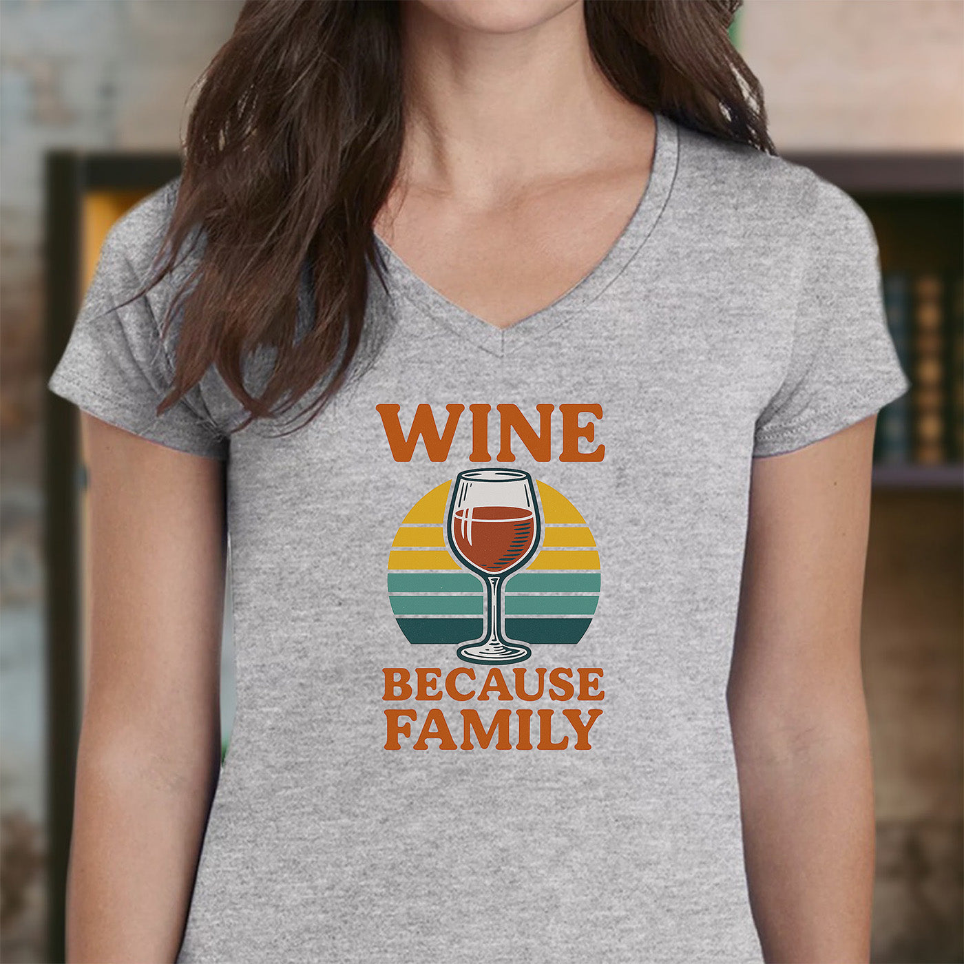woman wearing gray v-neck t-shirt with wine glass and text wine because family funny design
