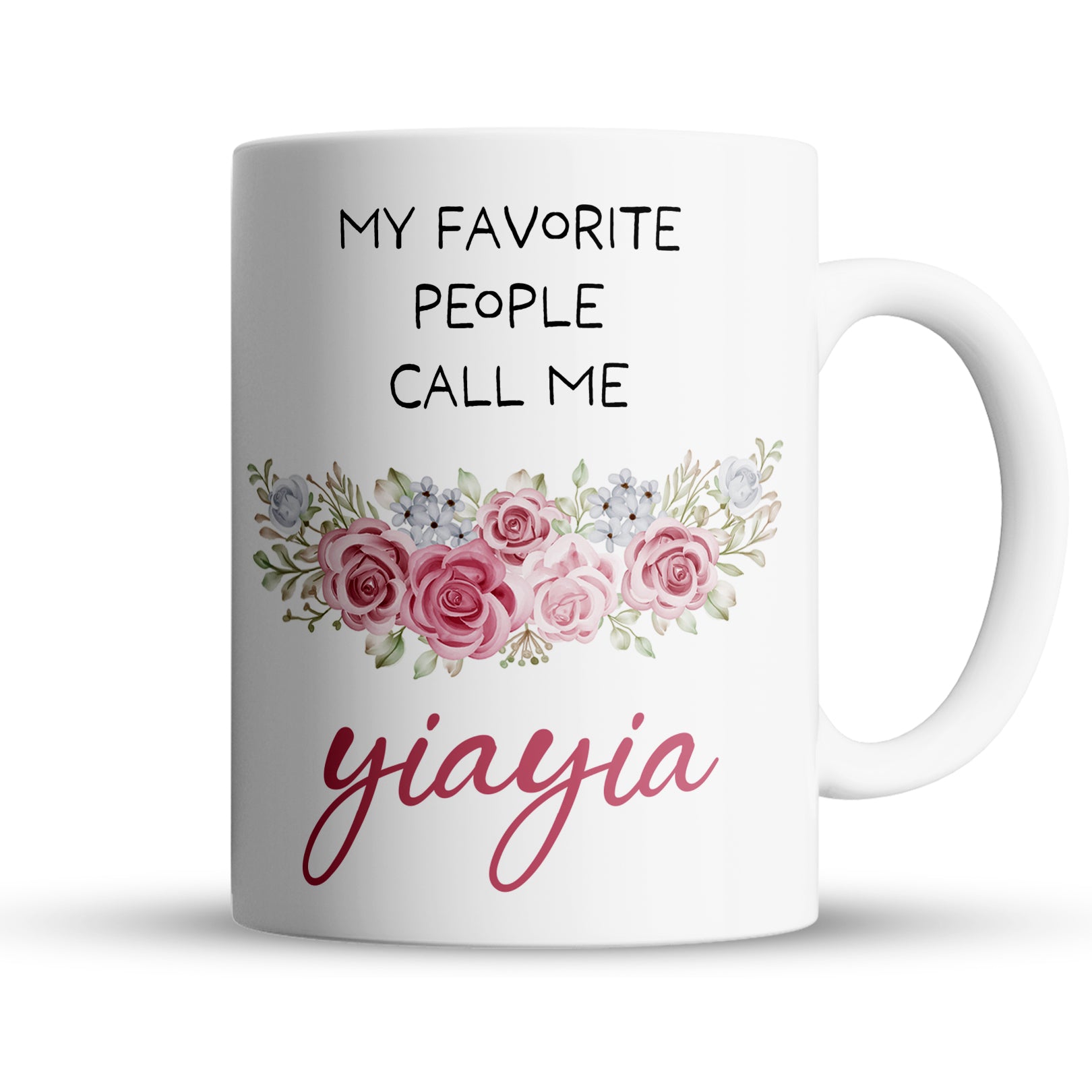 White ceramic mug with text My favorite people call me Yiayia and floral design.
